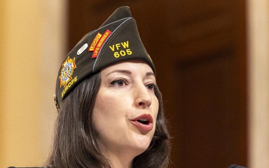 A woman wearing a hat speaks.